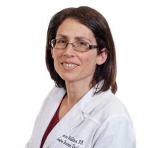 head shot of physician assistant Donna Robbins, a white woman with glasses, shoulder-length brown hair, and wearing a lab coat